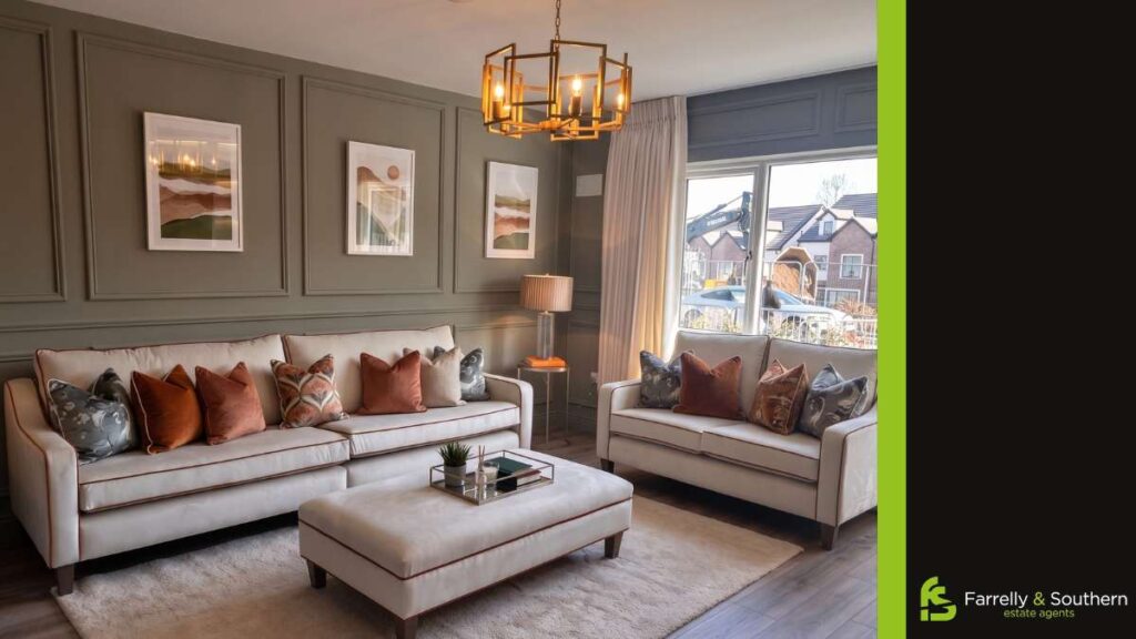 mint green walled living room with modern geometric chandelier and white sofas with cool colored throw pillows | Farrelly and Southern