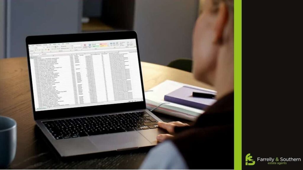 over the shoulder shot of a man looking at his laptop with a spreadsheet of the price register in kildare | Farrelly and Southern